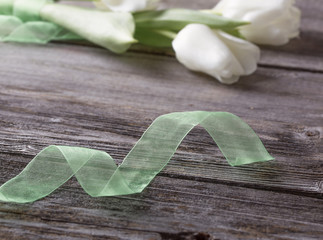 white tulips on wooden background