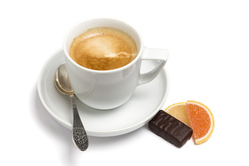 Cup of coffee, small spoon and sweets on a plate