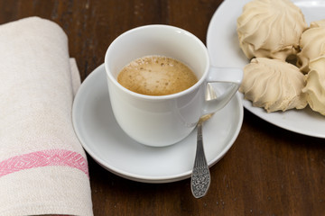 Cup of black coffee and marshmallows