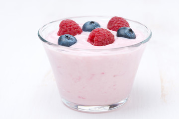 fruit yogurt with berries in a glass, close-up