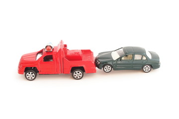toy police truck pulling car on white background
