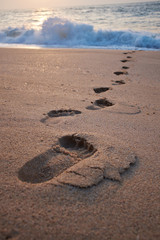 Footprints on the beach sand.Traces on the beach. Footsteps on t