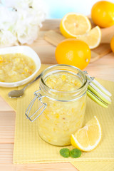 Tasty lemon jam on table close-up