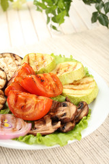 Delicious grilled vegetables on plate on table close-up