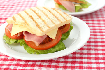 Tasty sandwich with ham on table