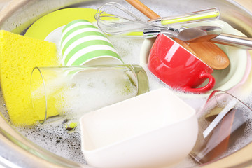 Utensils soaking in kitchen sink