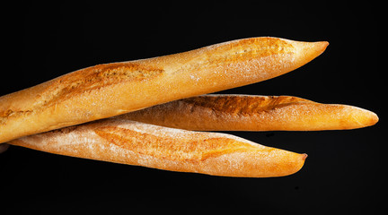 Baguette bread isolated on black background