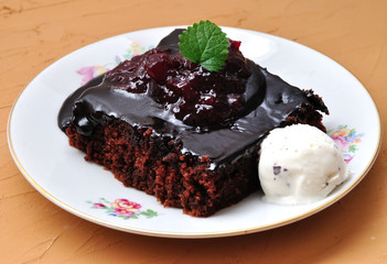 Chocolate cake with jam from berries and ice cream