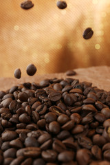 Coffee beans on table on brown background