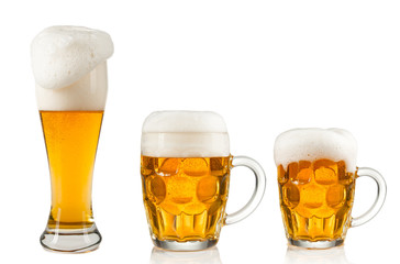 Collection of glasses of beer on white