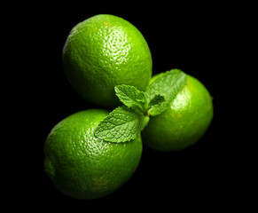 Fresh limes on dark background