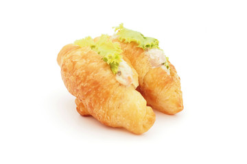 tuna salad croissant sandwich on white background