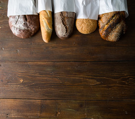 Fresh baked bread at wooden table