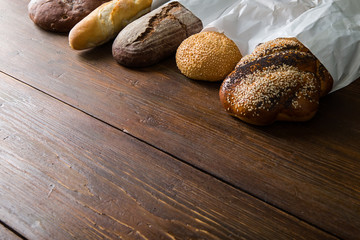 Fresh baked bread at wooden table