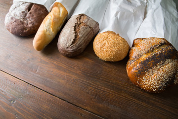 Fresh baked bread at wooden table