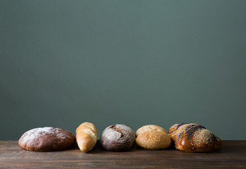 Fresh baked bread at wooden table