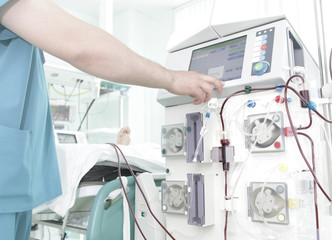 Doctor controls the process of dialysis in hospital