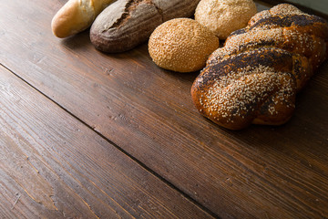 Fresh baked bread at wooden table