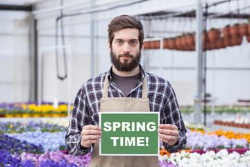 Male Garden Worker Holding an Open Signboard