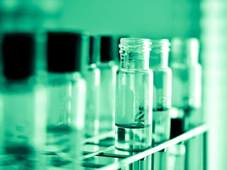 Laboratory glassware with liquid in green tone