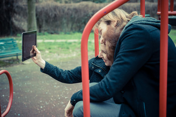 Obraz premium young modern stylish couple using tablet