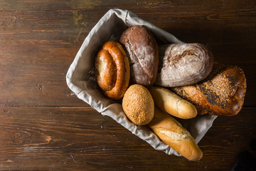 Photo of the assorted bread in wooden basket