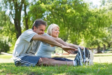 Fototapeta premium Couple stretching in the park