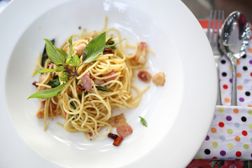 Spaghetti with ham , bacon, chilli and basil