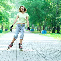 Roller skating sporty girl in park rollerblading on inline skate