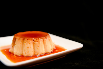 Caramel pudding on white plate