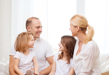 smiling family with two little girls at home