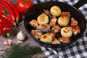 grilled meat and new potatoes and vegetables in a pan