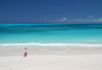 Girl on the desrt beach of Little Exuma, Bahamas