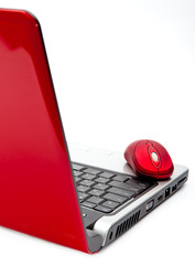 Red computer mouse and red notebook..