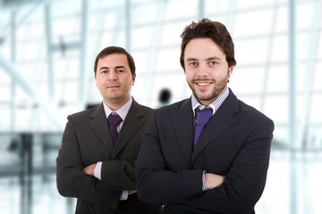 Two business men standing at the office