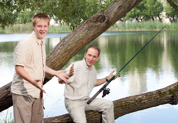 The father with the son on fishing, shows the size of fish