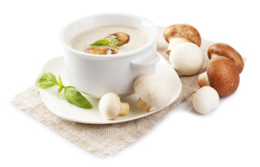 Mushroom soup in white bowl, on napkin, isolated on white