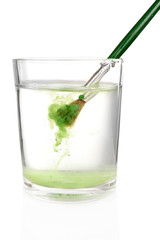 Brush with color paint in glass of water, isolated on white