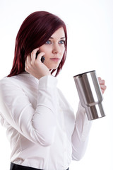 Woman talking by phone and drinking coffee