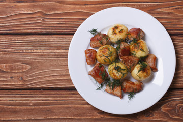 new potatoes with dill and fried pork on the table top view
