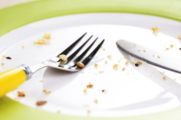 Plate with crumbs on wooden background