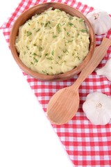 Delicious mashed potatoes with greens in bowl on table close-up