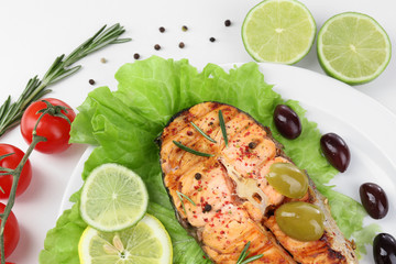 Tasty grilled salmon with vegetables, isolated on white