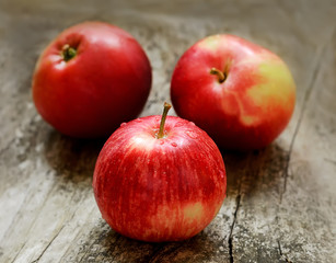 Red ripe apples on wooden surface