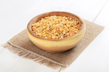 Split dried yellow peas in wooden bowl