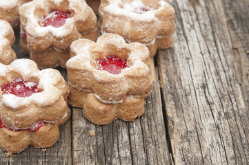 Jelly cookies flower with red jam homemade on vintage table top