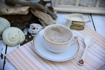 Morning coffee in white, off white, sea debris on the back