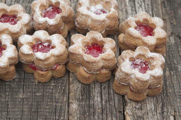 Jelly cookies flower with red jam homemade on vintage table top