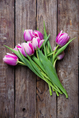 tulips on an old rustic wooden background