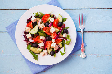 Greek salad on wooden background
